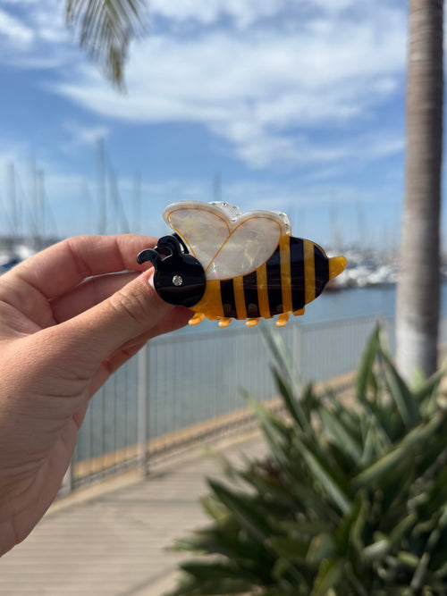 Side view of bumblebee hair claw clip showing stripe detail and pearlescent wings