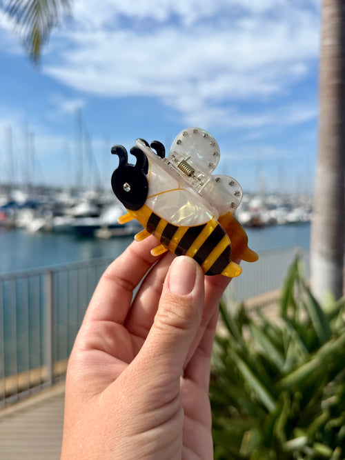 Bumblebee hair claw clip with yellow and brown stripes, rhinestone wings, and black head