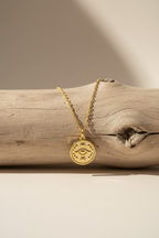 Celestial eye necklace on wood branch