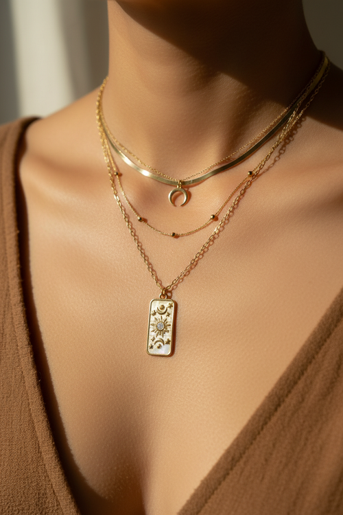 Celestial necklace layered with other gold necklaces