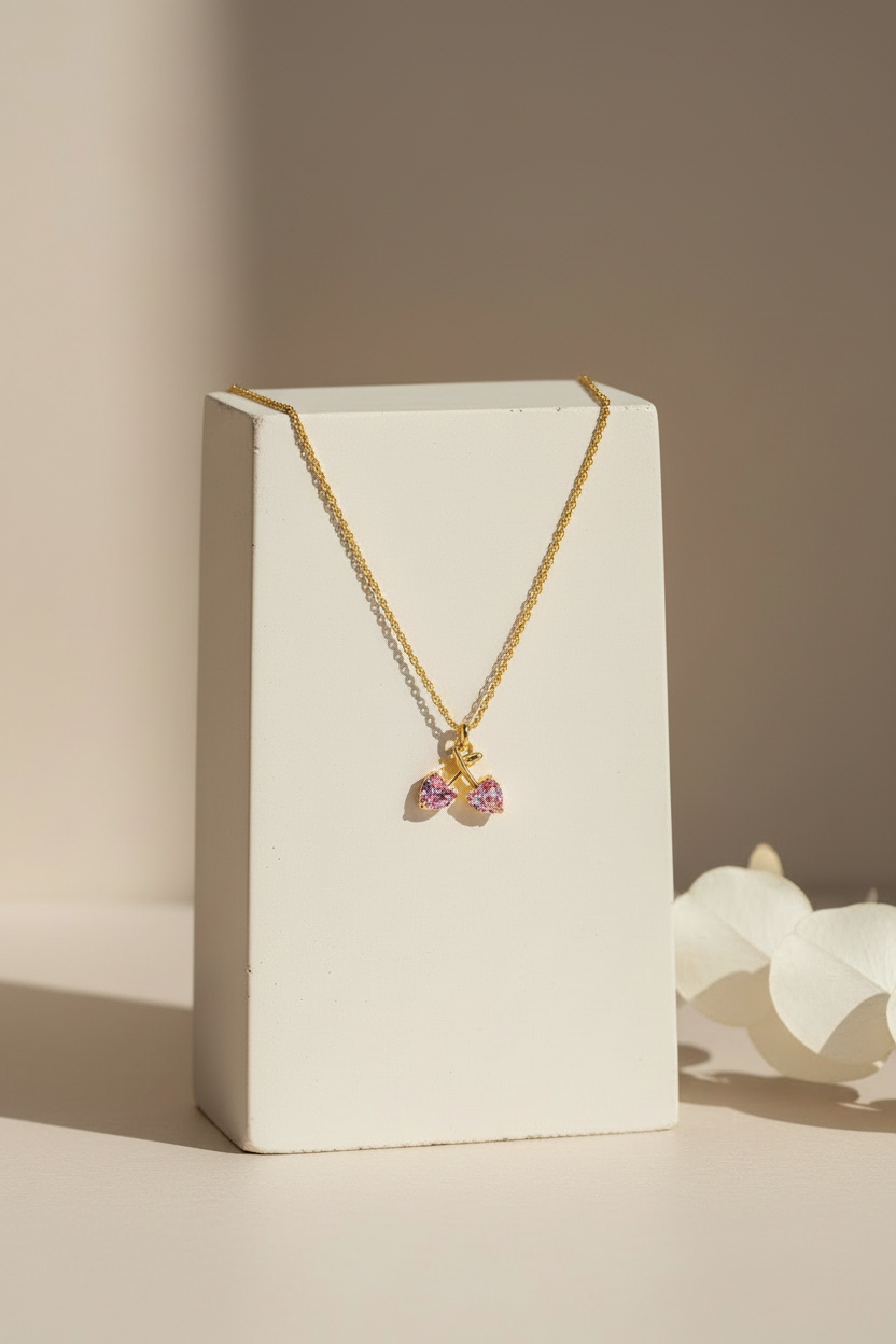 Cherry necklace on white stand