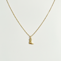 Cowboy boot necklace on white surface