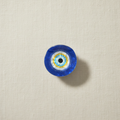 Evil eye hair claw on pale cream linen