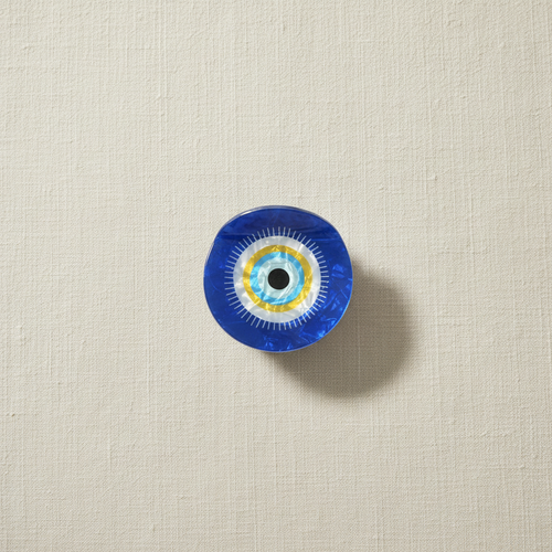 Evil eye hair claw on pale cream linen