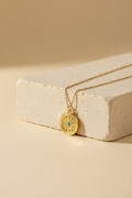 Evil eye necklace on cream stone block