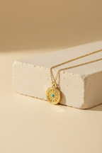 Evil eye necklace on cream stone block