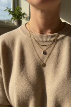 Layering blue gemstone necklace with other gold chains