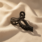 Medium black bow hair claw clip on cream linen