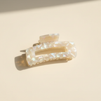 Champagne iridescent rectangular hair claw clip on warm ivory background