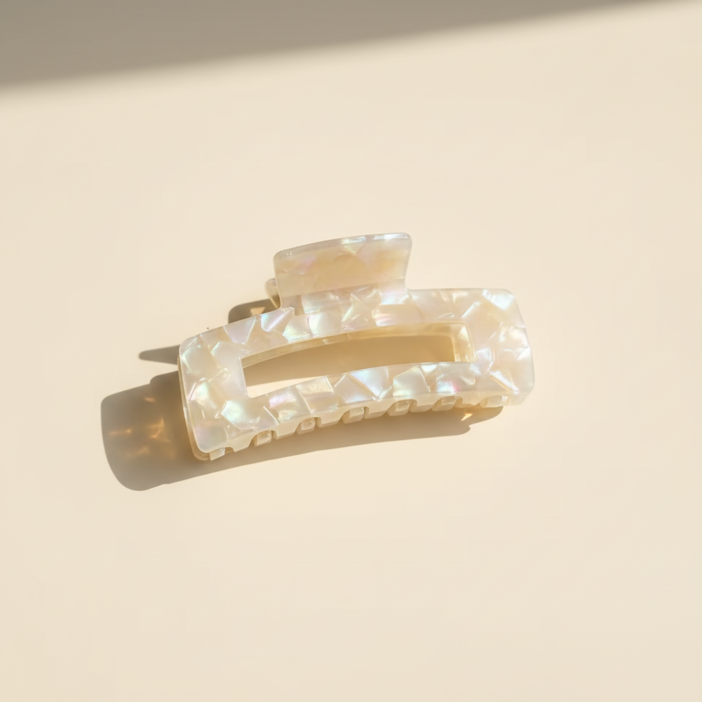 Champagne iridescent rectangular hair claw clip on warm ivory background