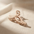 Medium beige bow hair claw clip on cream linen