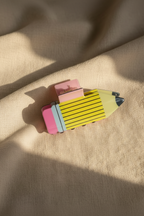 Yellow pencil hair clip on linen bedding
