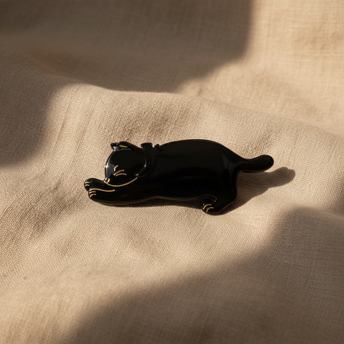 Black cat hair claw clip on natural linen