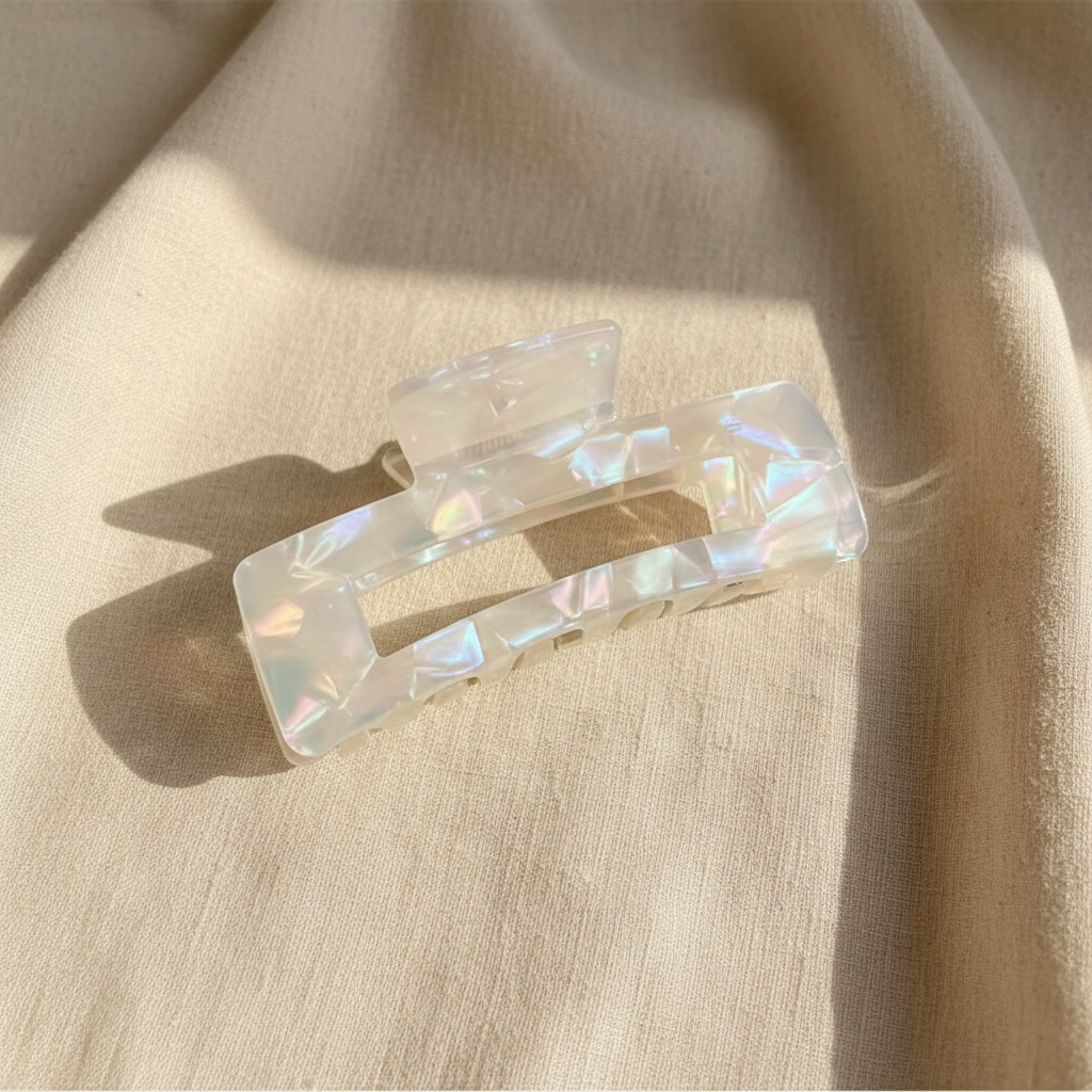 Clear iridescent rectangular hair claw clip on cream linen