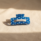 Cobalt blue evil eye hair claw clip on cream linen