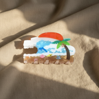 Overhead view of beach scene hair clip