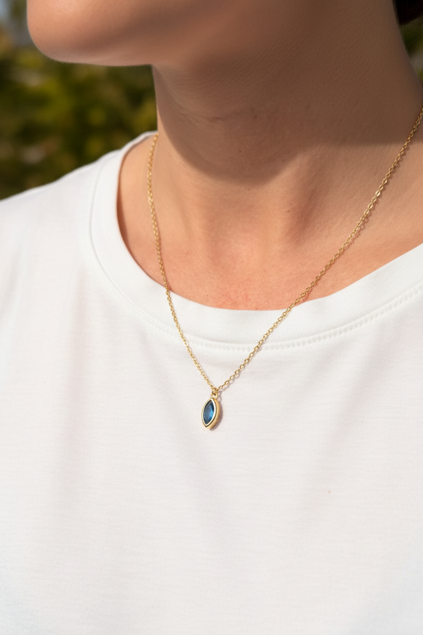 Woman wearing blue gemstone necklace outdoors