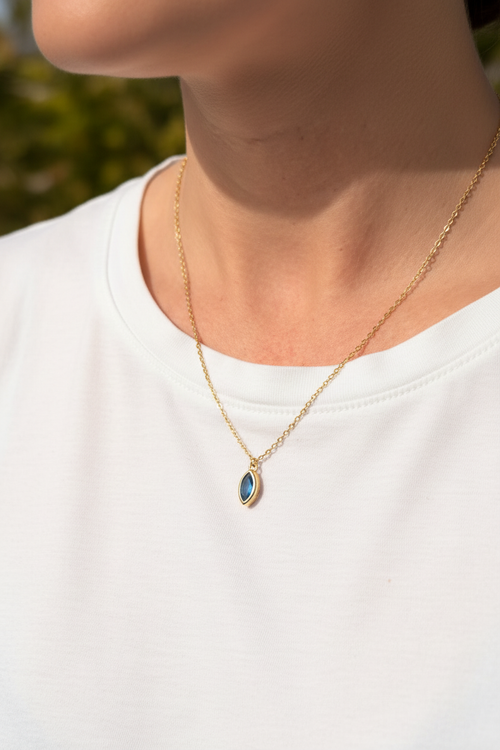 Woman wearing blue gemstone necklace outdoors