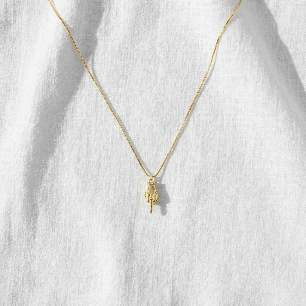 Middle finger necklace on linen