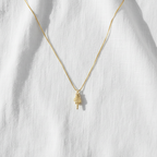 Middle finger necklace on linen