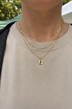 Necklace layered with other chains