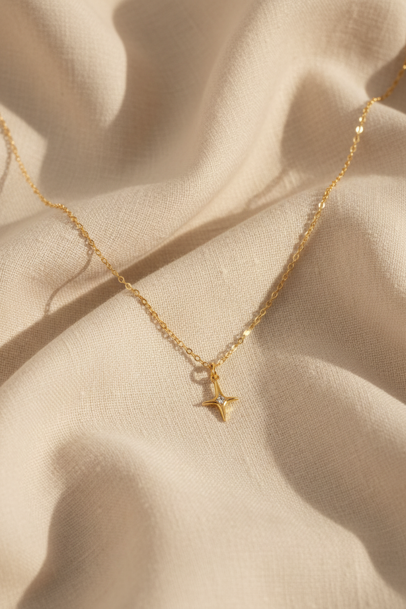 North star necklace on cream linen