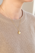 Seashell necklace side beige sweater