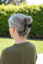Silver-gray French twist with olive sweater