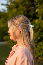 Straight blonde half-up with peach linen