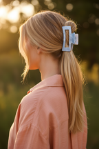 Straight blonde low ponytail with peach linen
