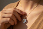 Sun and moon necklace hand touching pendant