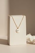 Sun and moon necklace on display stand