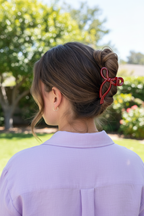 Wavy brown half-up with lavender blouse