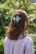 Wavy brown half-up with lavender blouse