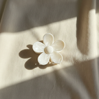 White flower clip on beige cotton